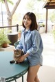 A woman sitting at a table with a cat.