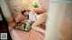 A woman laying on a bed with a tray of food.