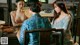 A group of women sitting around a wooden table.