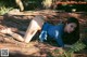 A woman laying on the ground in a blue dress.