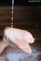 A person's hand is covered in soap and water.