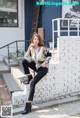 A woman sitting on the steps of a building.