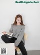 A woman sitting on a chair holding a book.