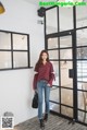 a woman standing in front of a glass door