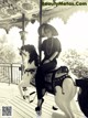 A woman sitting on a carousel with a horse.